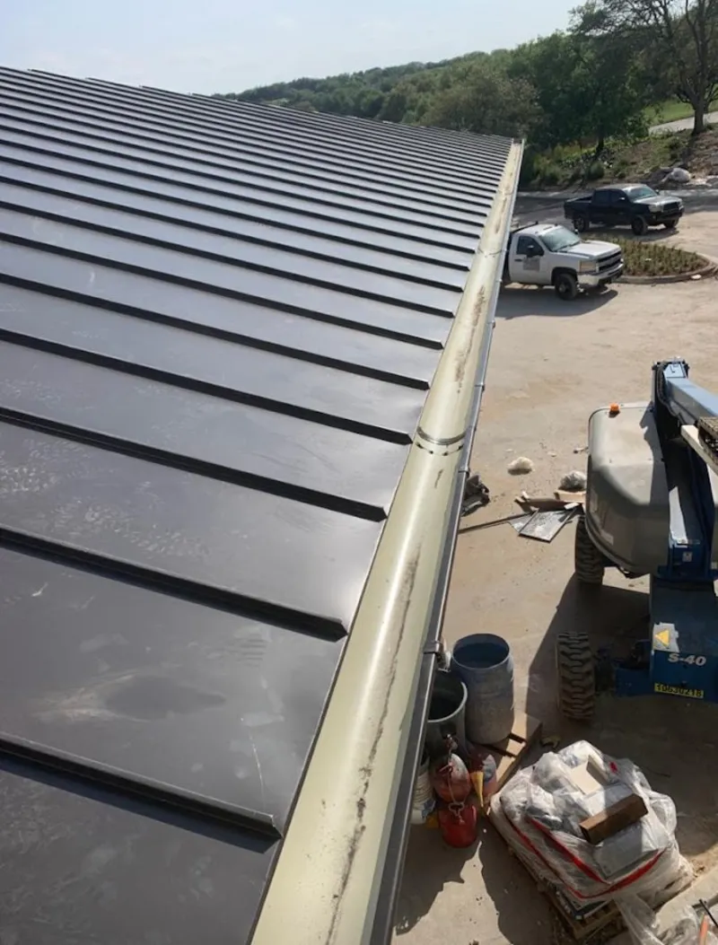 Standing seam panel and gutter detail on a metal roofing jobsite in East Alton